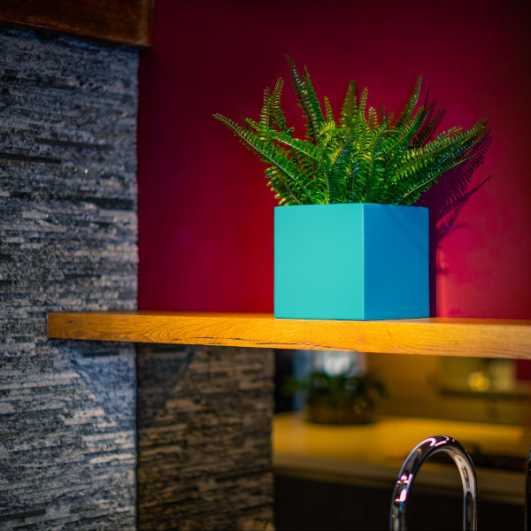 A light blue cabinet top cube planter